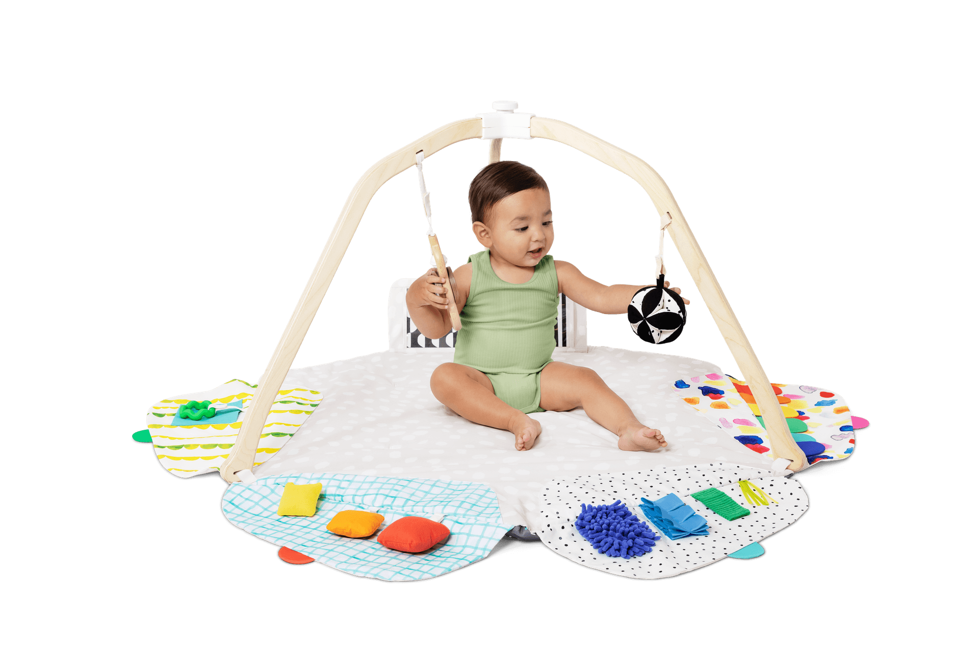 Baby playing with the High-Contrast Ball and the Batting Ring from The Play Gym by Lovevery